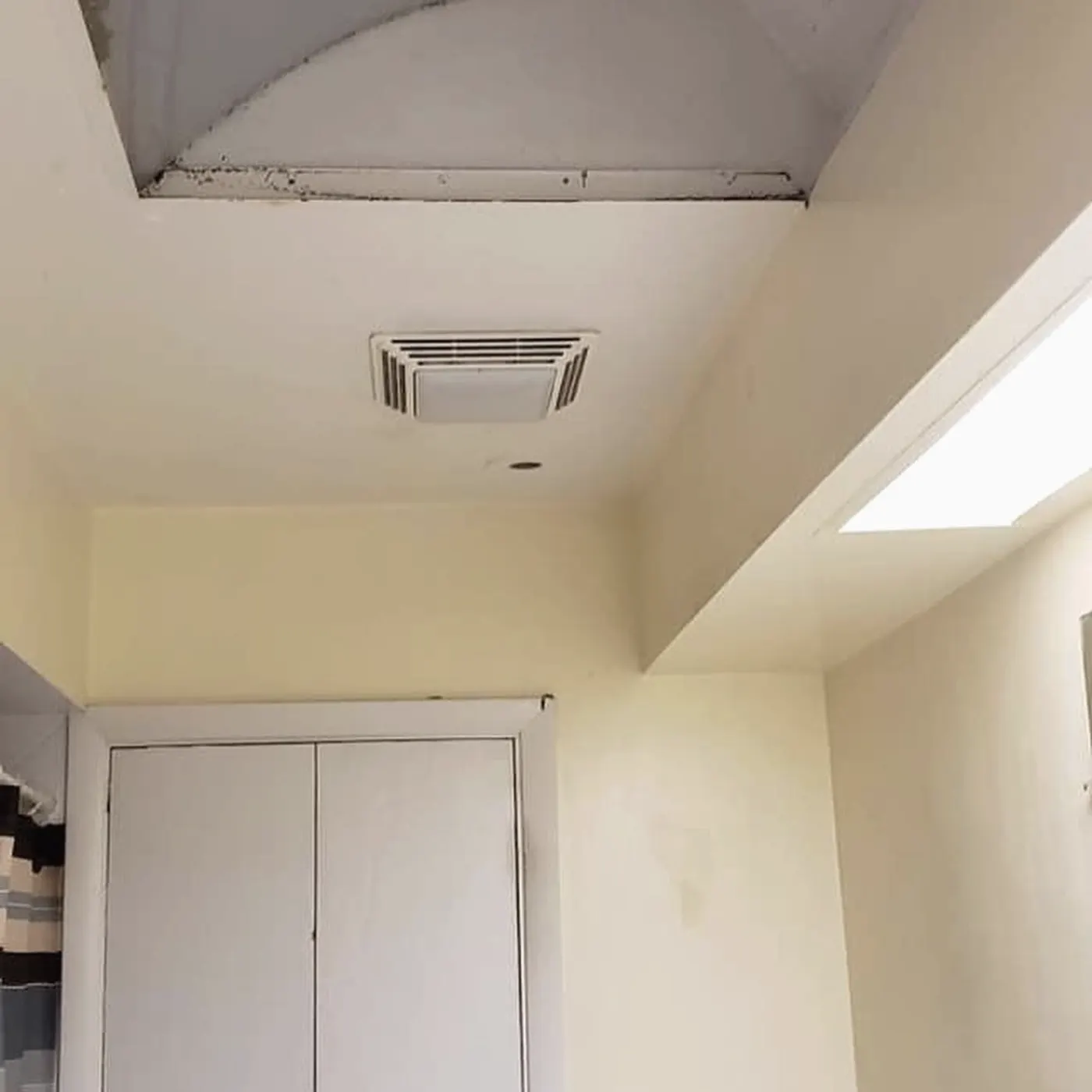New drywall ceiling with a vented exhaust fan over the shower