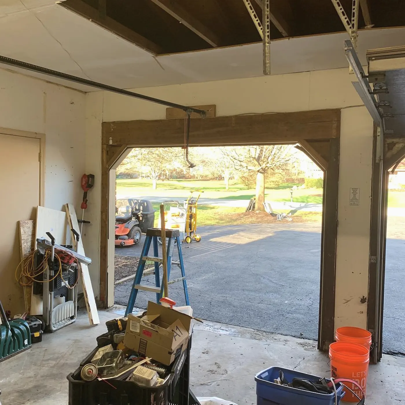 Inside the garage with the old door removed and the opening open to the street